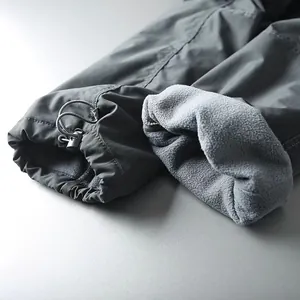 Detail of men's cargo pants showing adjustable cuff drawstring and soft fleece lining