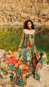 Vibrant colorful printed strapless maxi dress featuring a pleated flowing skirt design