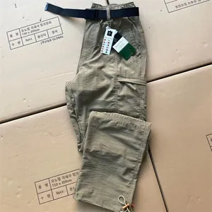 Detail of khaki quick-dry cargo pants with utility pockets and adjustable drawstring hem
