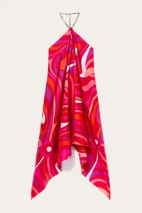 Full view of vibrant psychedelic print and asymmetric hem of the satin halter dress