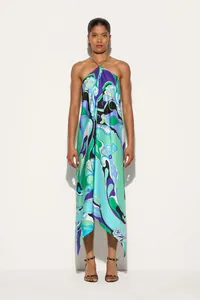 Detail view of a vibrant floral satin halter midi dress with a unique irregular hem.