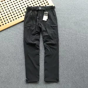 Close-up of black quick-dry cargo pants with multi-pockets and adjustable belt.