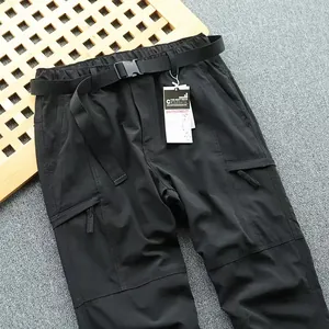 Detail of lightweight black cargo pants for men with quick-dry fabric and built-in belt