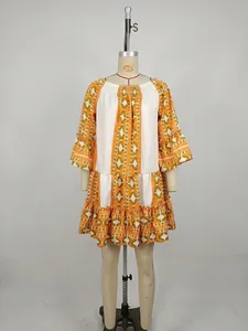 Detailed view of the geometric pattern and flared sleeves on a bohemian style dress