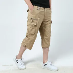 Side view showing the fit and multi-pocket detail of men's khaki cotton cargo shorts