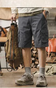 Men's charcoal cotton cargo shorts shown on model with a rugged outdoor aesthetic style