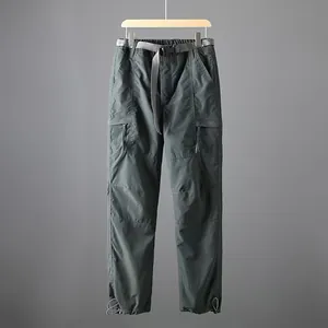 Detail view of men's quick-dry tactical cargo pants with belt on a wooden hanger