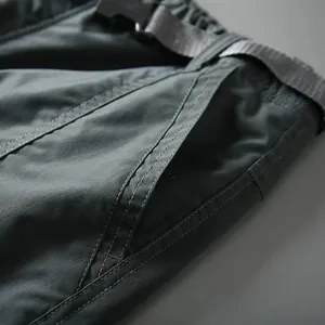Close-up detail of men's quick-dry cargo pants with functional belt and pocket
