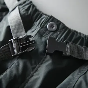 Detail view of the durable plastic buckle and fabric texture on men's quick-dry cargo pants