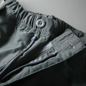 Close-up detail showing the zipper and button closure on men's quick-dry cargo pants