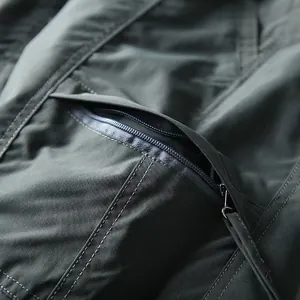 Macro view of the zipper pocket and fine stitching on men's breathable quick-dry cargo pants
