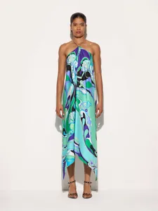 Elegant satin halter neck dress with abstract blue and green print and irregular hem