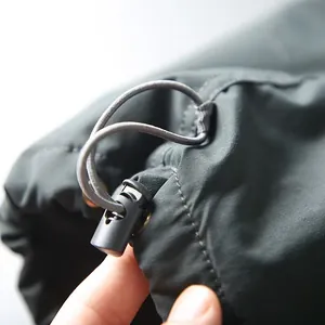 Close-up detail of the adjustable elastic drawstring toggle on men's quick-dry cargo pants