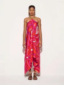 Elegant satin halter maxi dress with vibrant psychedelic print and irregular hemline