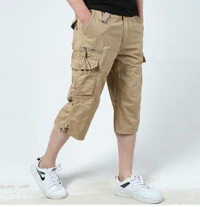 Close-up view of men's khaki cotton cargo cropped pants with multi-pocket design