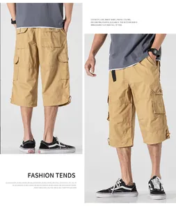 Detailed view of men's loose khaki cargo shorts with multiple utility pockets and drawstring hems