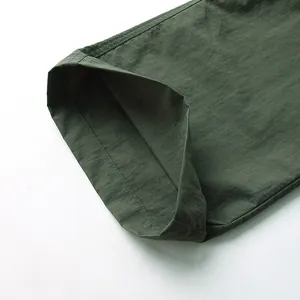 Close-up of leg hem of dark green waterproof and quick-dry outdoor cargo pants for men