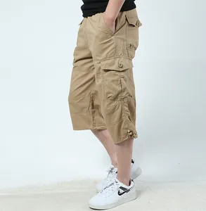 Macro detail shot of khaki men's multi-pocket cargo shorts featuring durable cotton fabric