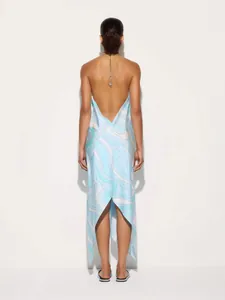 Elegant backless halter maxi dress featuring blue swirl print and a stylish irregular hem