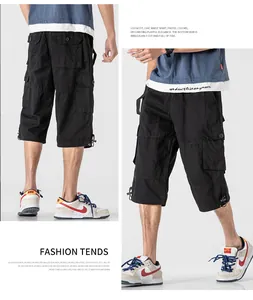 Detail of men's loose cargo shorts with multiple pockets in black 3/4 length
