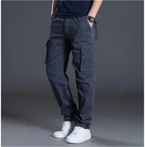 Detail view of men's dark blue cargo pants with multiple pockets and straight fit