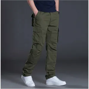 Detailed side view of army green multi-pocket cargo pants for men styled with white sneakers