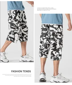 Detail view of men's loose camo cargo shorts with multiple pockets and 3/4 length