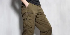 Detailed macro view of men's loose multi-pocket olive cargo pants with side pockets