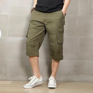 Loose fit men's olive green cargo shorts featuring multiple pockets for casual outdoor style