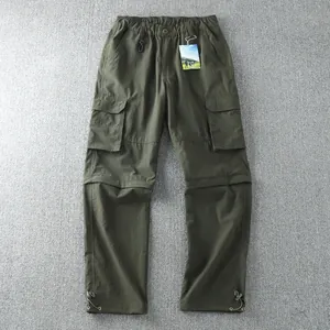 Detail view of army green convertible cargo pants with multiple utility pockets
