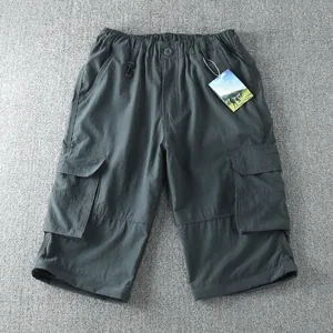 Detail of men's dark grey outdoor cargo shorts with elastic waist and multi-pockets