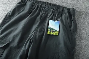 Close-up detail of men's lightweight outdoor cargo pants featuring elastic waist and pockets