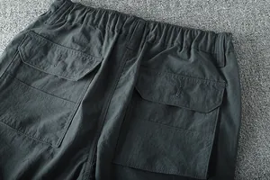 Close-up of elastic waist and cargo pockets on men's lightweight outdoor pants
