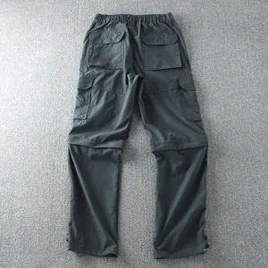 Detail view of men's dark grey outdoor cargo pants showing back pockets and stitching.
