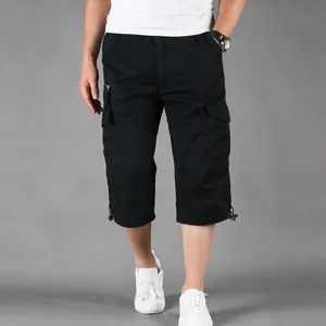 Close-up detail view of men's casual black cotton cargo 3/4 length shorts with pockets