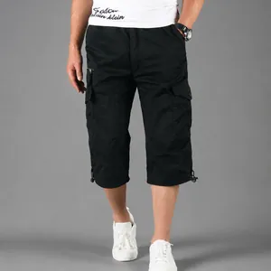 Close-up detail view of men's casual black cotton cargo 3/4 length shorts with pockets