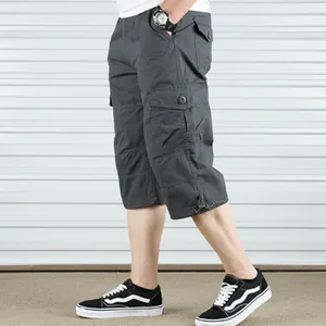 Side view detail of men's dark grey cotton cargo shorts with multiple pockets.
