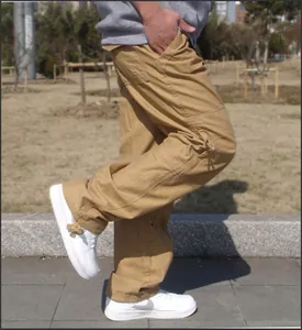 Detailed side view of men's loose khaki cargo pants featuring multiple functional pockets