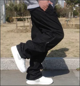 Detailed view of black multi-pocket cargo pants with side zipper and loose fit style