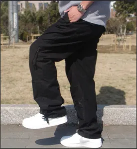 Detailed side view showing black loose-fit cargo pants for men with multiple pockets