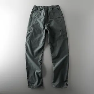 Back view of men's waterproof tactical cargo pants with elastic waist and pockets.