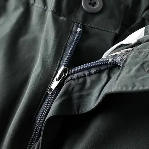 Close-up detail of high-quality metal zipper and button on durable outdoor hiking pants