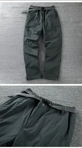 Detail of men's waterproof windproof softshell pants with belt and fleece lining