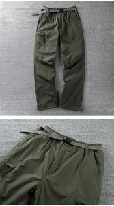 Detailed macro view of olive green outdoor windproof softshell pants with waist belt