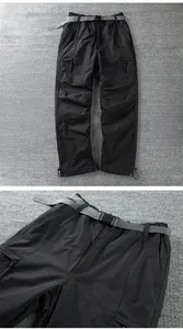 Detailed view of black winter softshell pants featuring nylon belt and cargo pockets