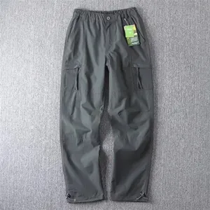 Men's dark grey straight leg cargo pants with side zip pockets and hem drawstrings