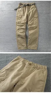 Detailed view of durable outdoor softshell cargo pants with elastic waistband and belt accessory