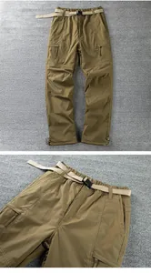 Detailed view of men's windproof outdoor softshell pants featuring a buckle belt and pockets