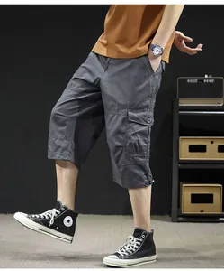 Close-up of lightweight grey cargo shorts on a model, featuring side pockets and loose fit