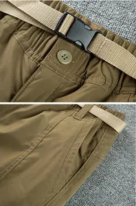 Close-up detail showing the waist buckle and side pocket of men's softshell pants